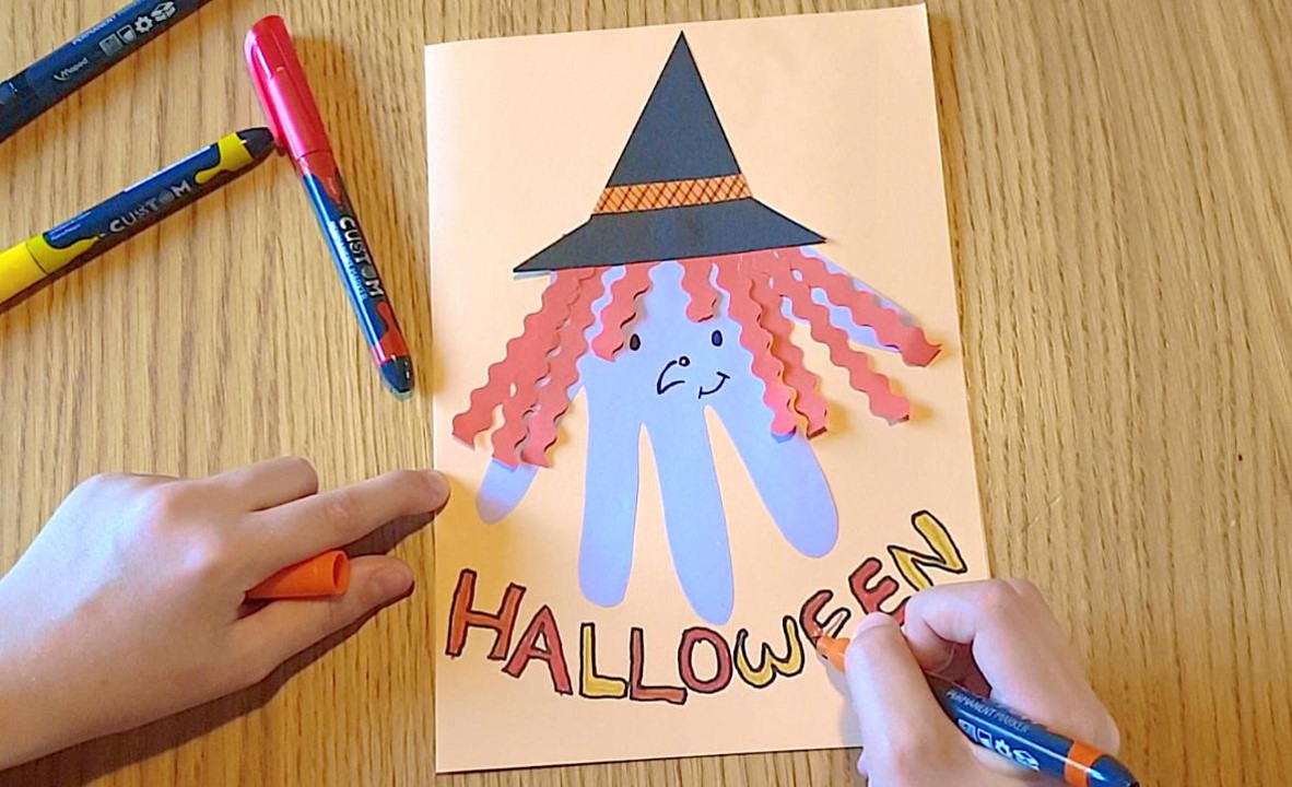 A homemade card showing a witch with Halloween written underneath