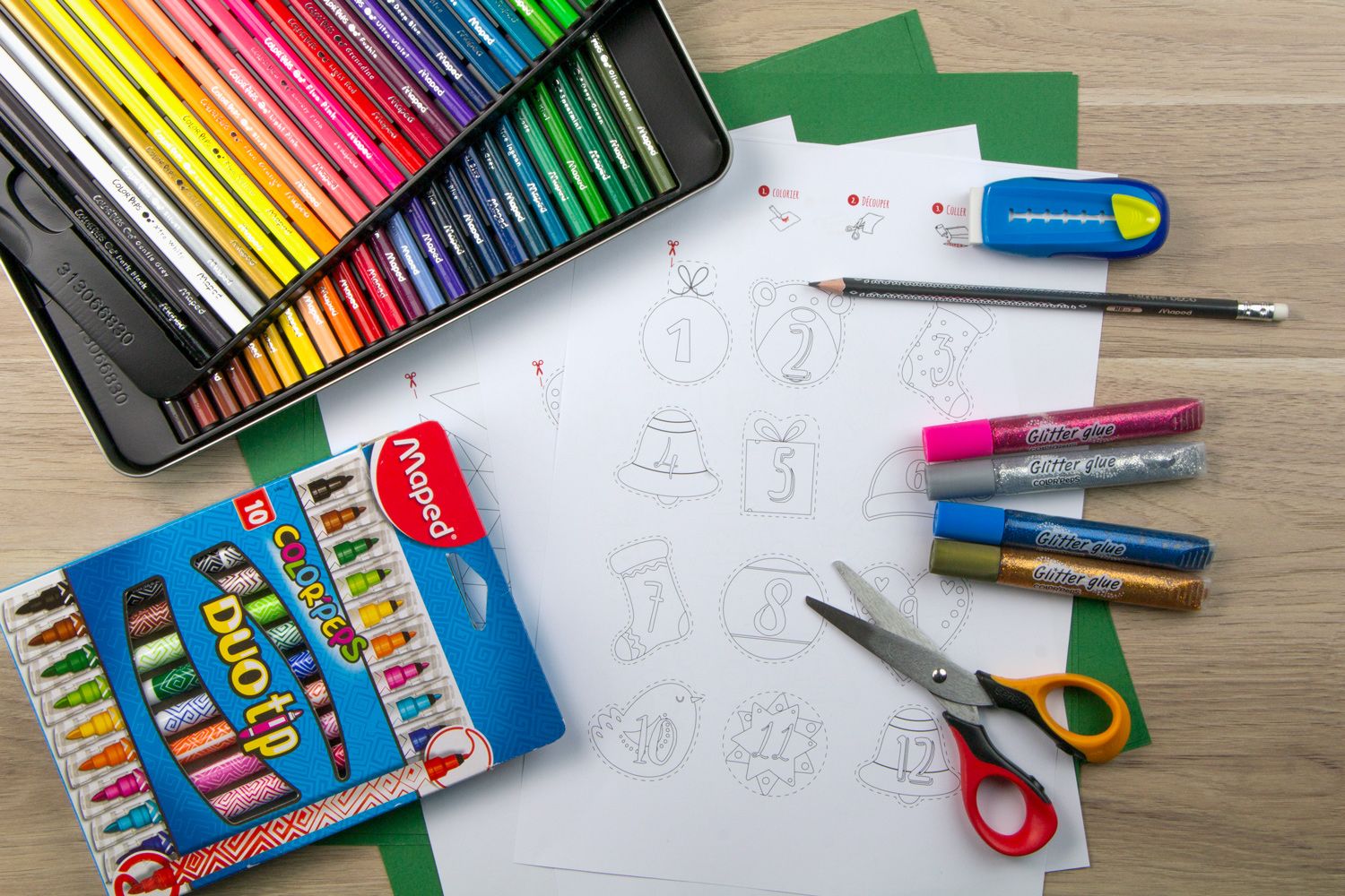 A template for numbered labels with scissors and felt pens lay on the desk