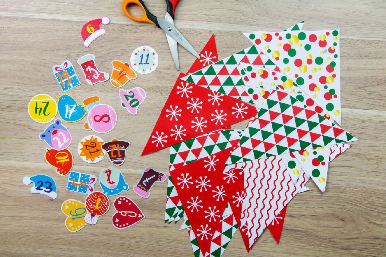 patterned paper and decorated numbers lay on a desk next to scissors