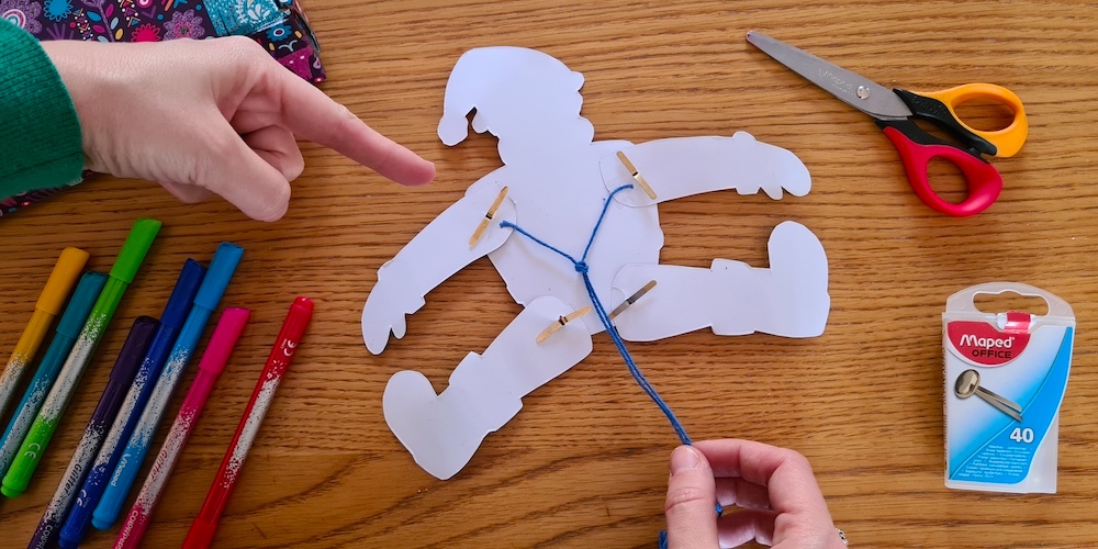 The back of a Santa puppet showing the strings on the back