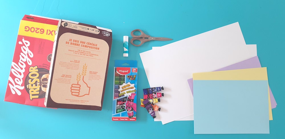 Two cereal boxes with stationery and paper laying on a desk