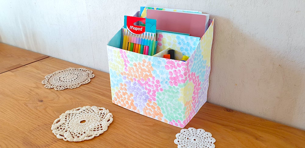 Homemade desk tidy filled with stationery