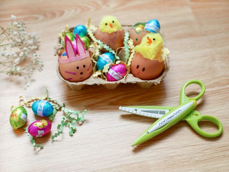 An Easter decorated egg box with a pair of scissors on a table