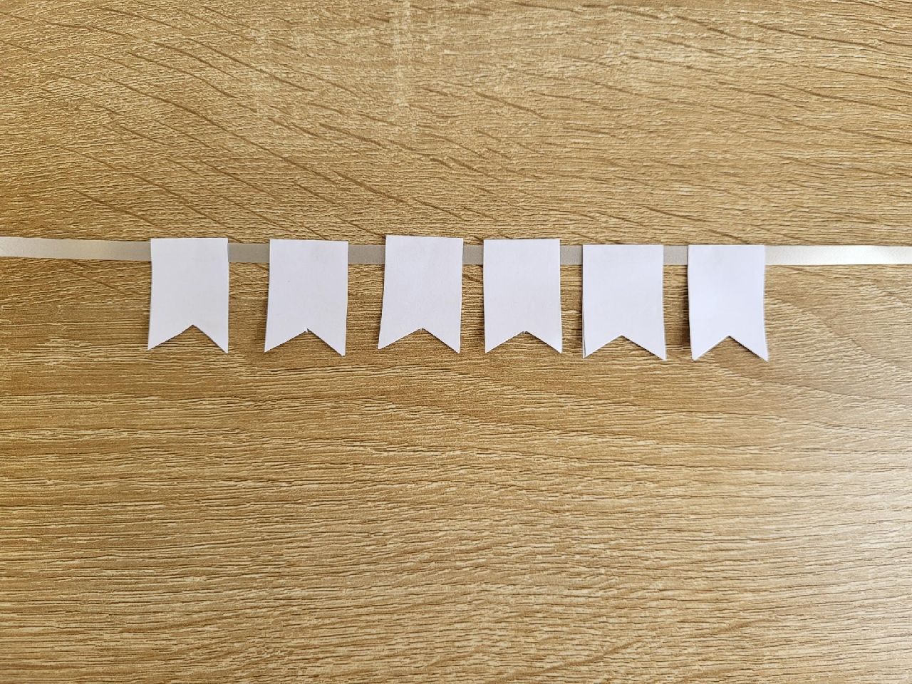 A row of 6 bunting flags on a ribbon