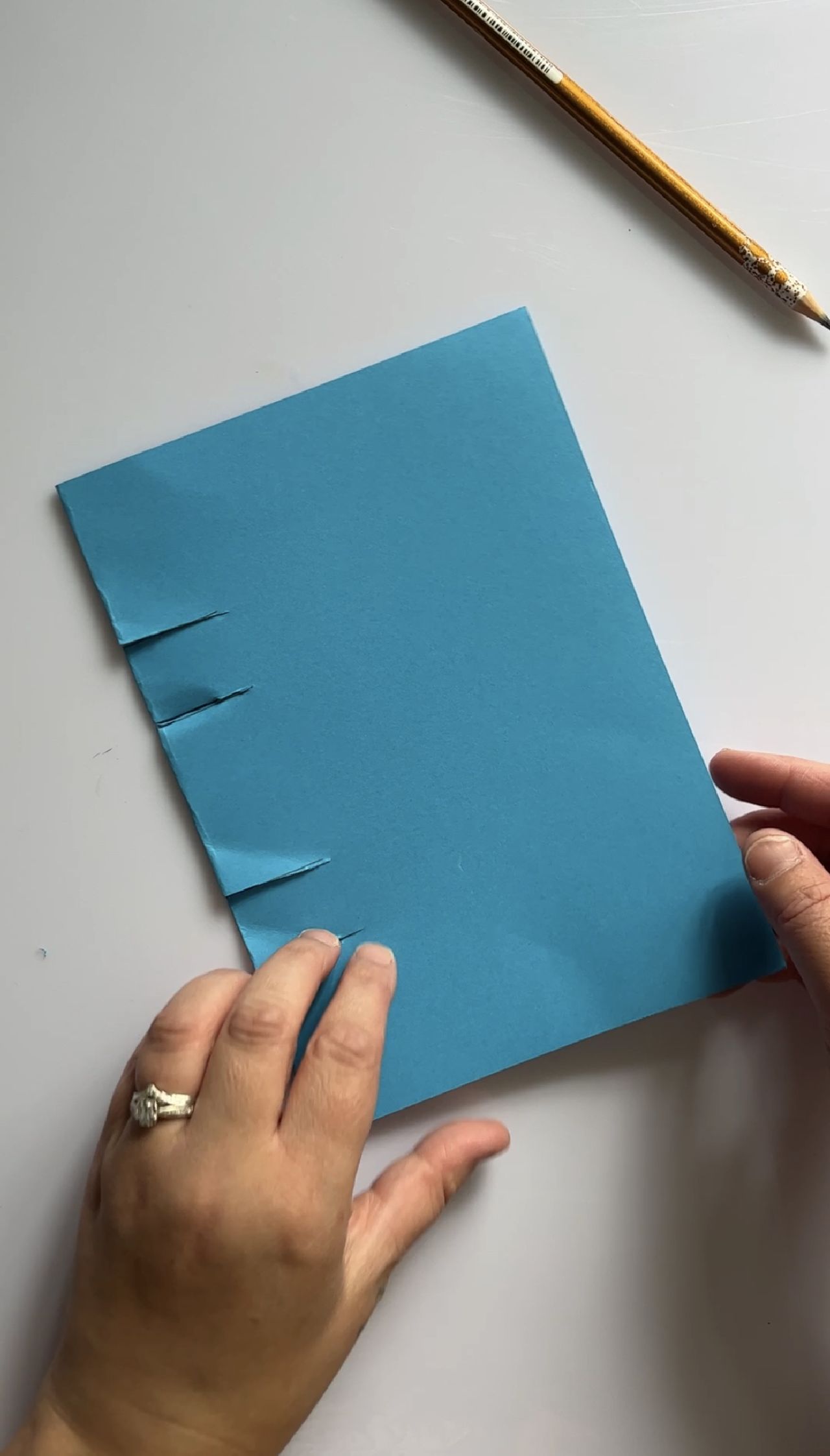 A folded sheet of blue paper laying on a desk