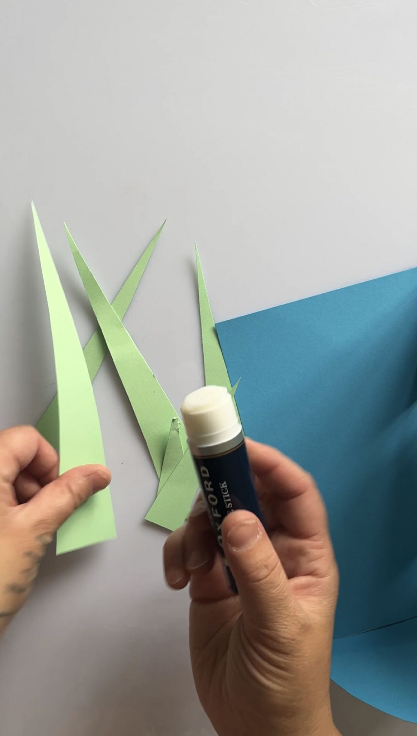 Some strips of green paper and a glue stick