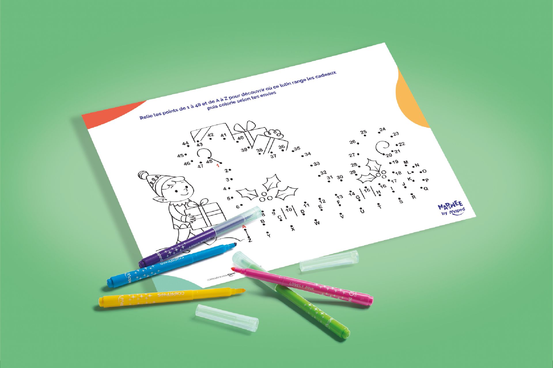 A dot to dot activity sheet laying on a green background with coloured felt pens