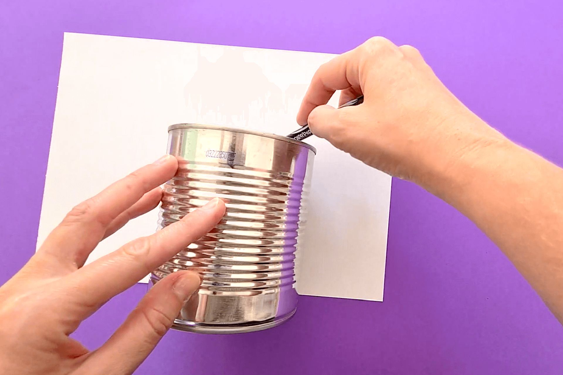 a tin can laying on a sheet of paper