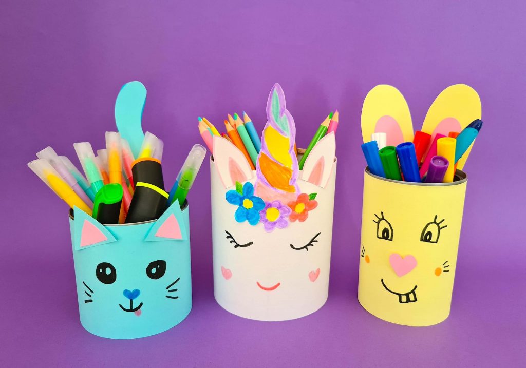Cat, unicorn and rabbit pencil pots holding pens and pencils