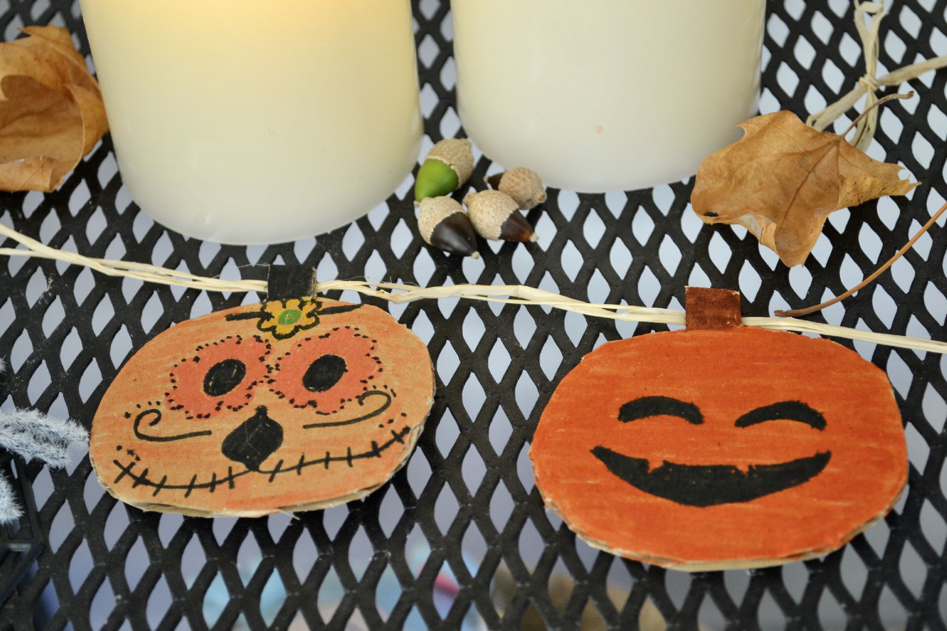 The finished decorated pumpkins attached to the string
