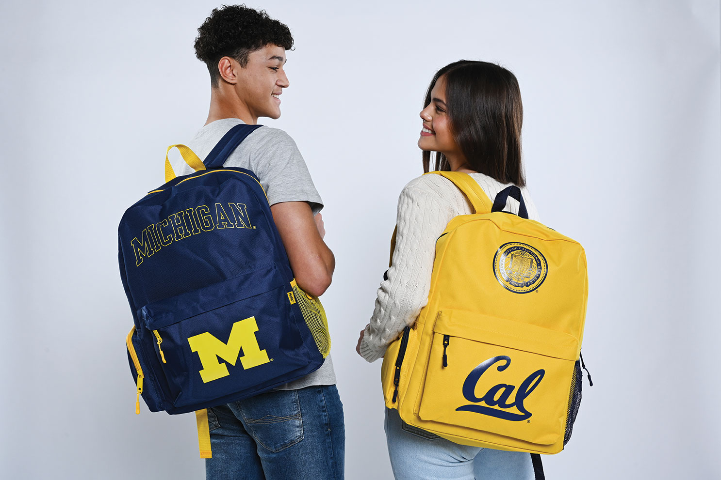 2 young people with Michegan and Cal backpacks
