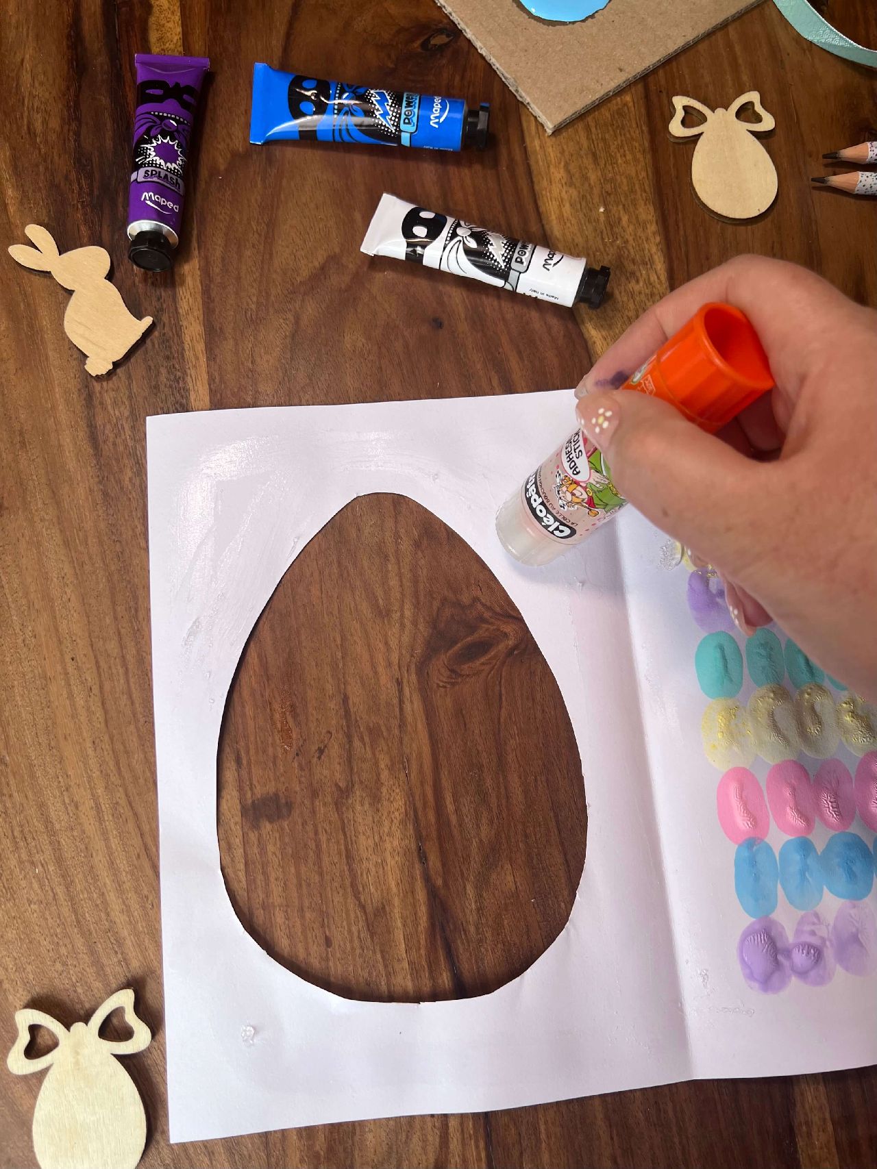 Applying glue around the cut out egg
