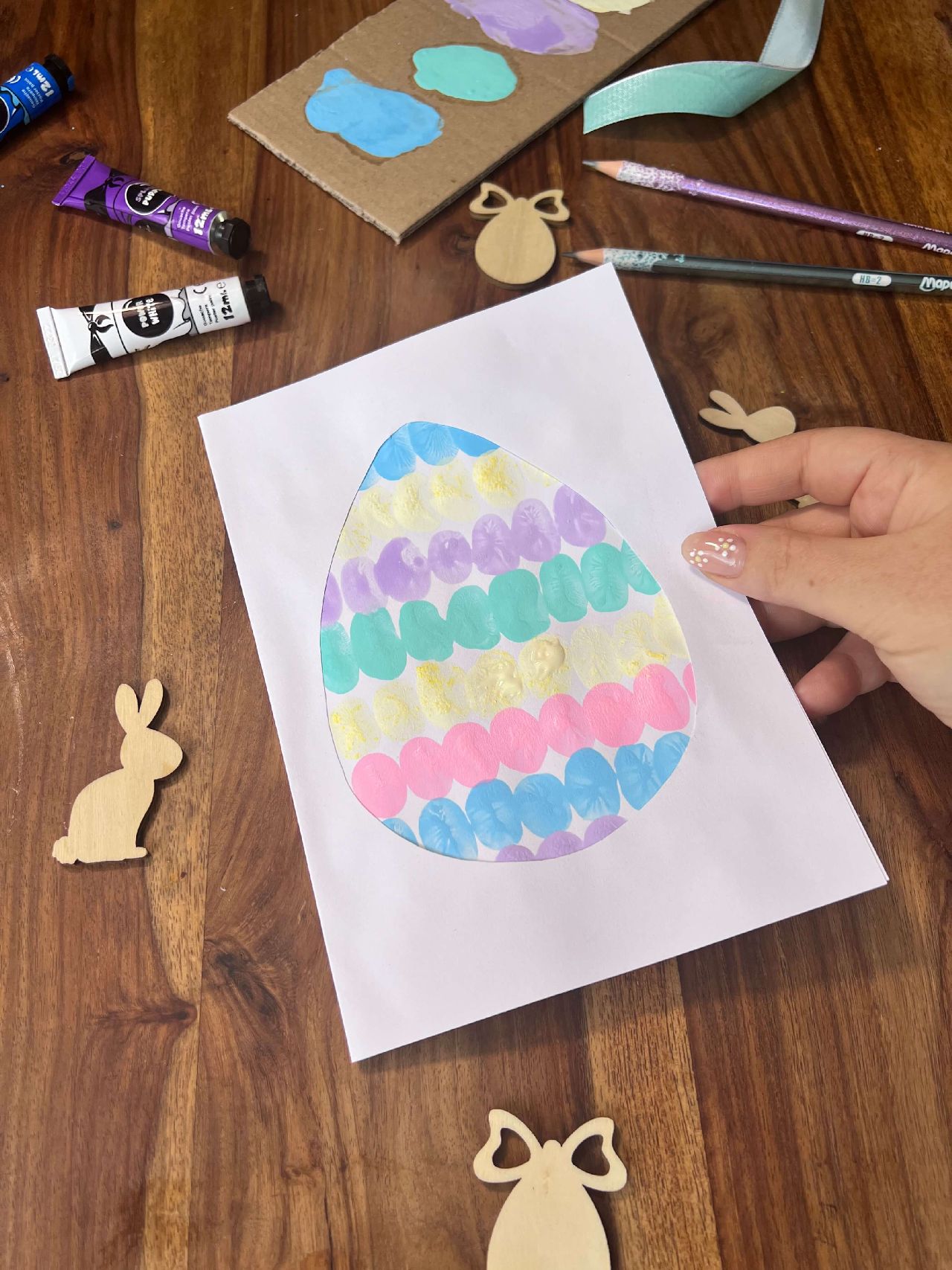 Cut out egg shape with painted design showing through