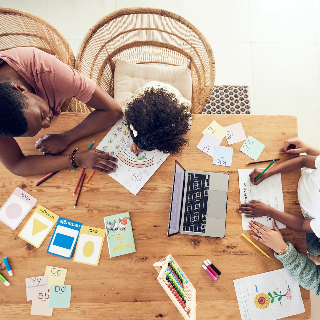 parents and children at the table doing some homework