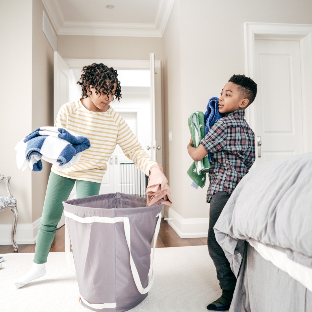 two young boys cleaning their room