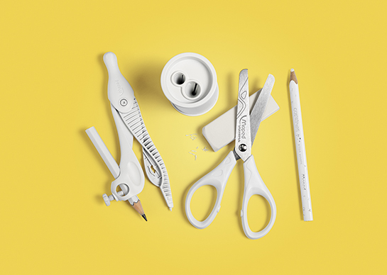 A selection of stationery products on a yellow background